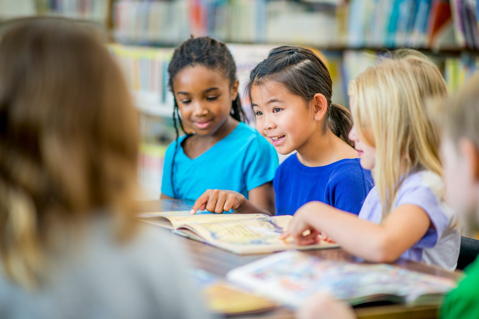 Children reading book at school